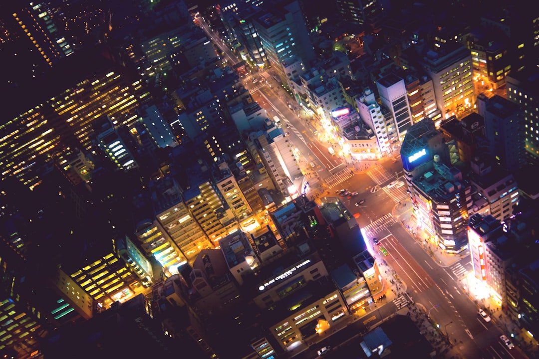 Vista noturna iluminada por letreiros neon em Tóquio, representando a indústria de entretenimento japonesa.